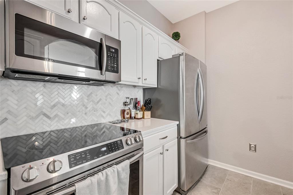 2817 Almaton Loop, Unit 301 Kissimmee, FL 34747 - Photo 11 of 51 a kitchen with granite countertop a stainless steel appliances and cabinets