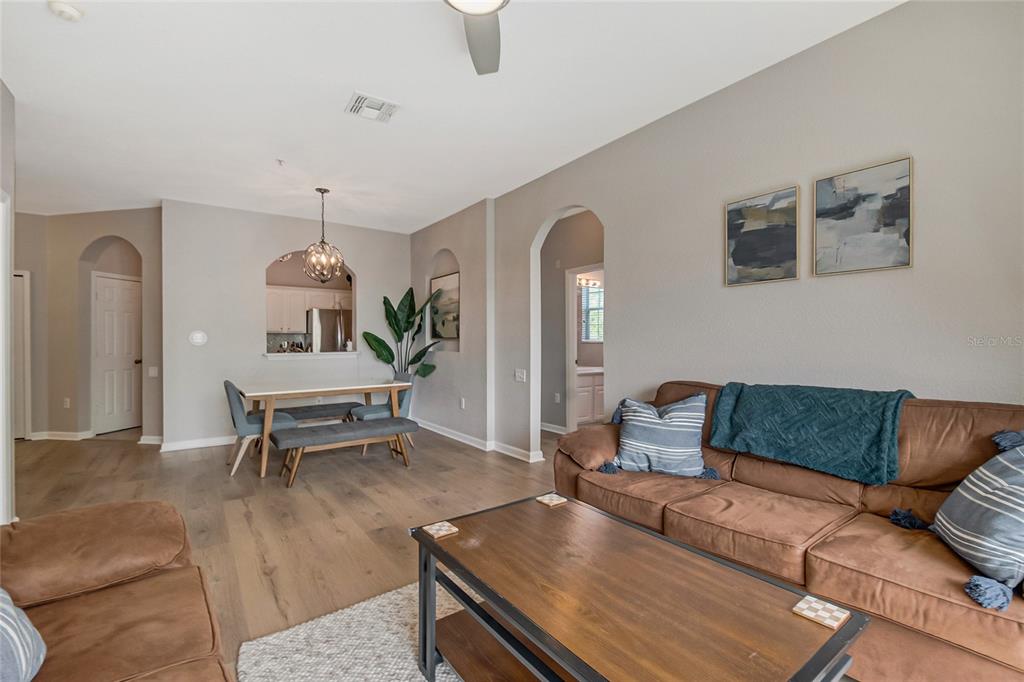 2817 Almaton Loop, Unit 301 Kissimmee, FL 34747 - Photo 17 of 51 a living room with furniture and wooden floor