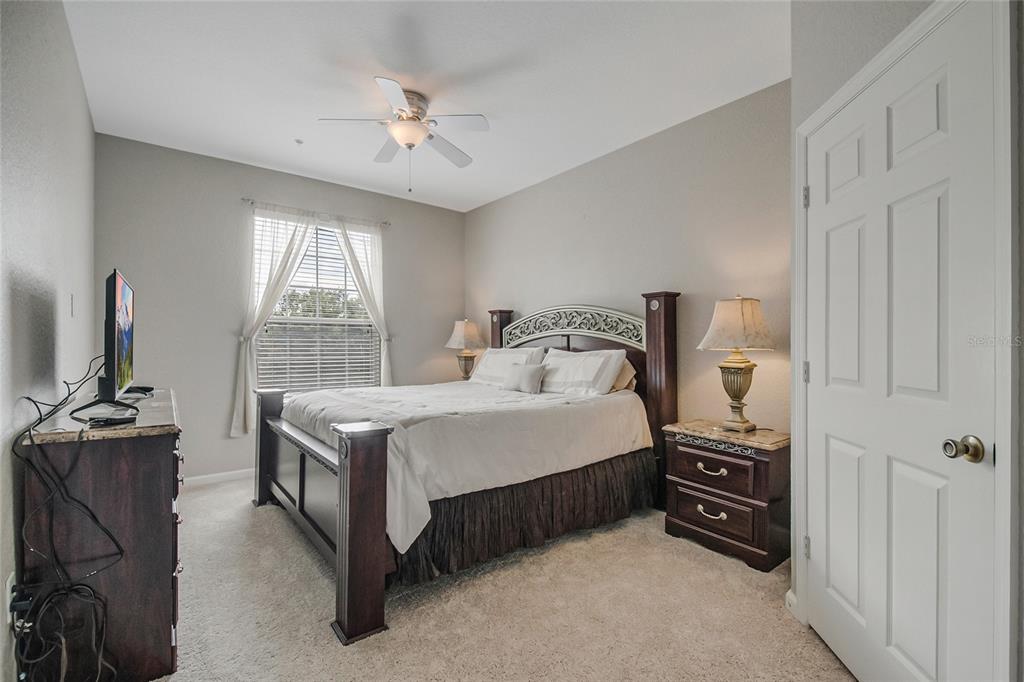 2817 Almaton Loop, Unit 301 Kissimmee, FL 34747 - Photo 18 of 51 a bedroom with a bed and a flat tv screen