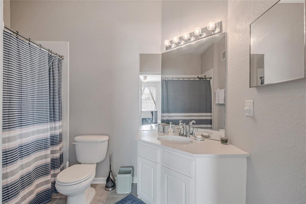 2817 Almaton Loop, Unit 301 Kissimmee, FL 34747 - Photo 20 of 51 a bathroom with a double vanity sink toilet and mirror
