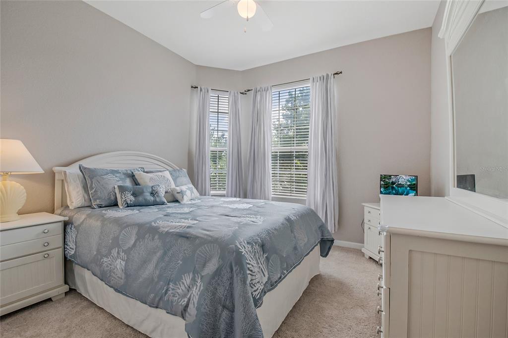 2817 Almaton Loop, Unit 301 Kissimmee, FL 34747 - Photo 23 of 51 a bedroom with a bed and a table