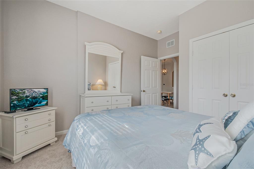 2817 Almaton Loop, Unit 301 Kissimmee, FL 34747 - Photo 24 of 51 a bedroom with a bed and a flat screen tv