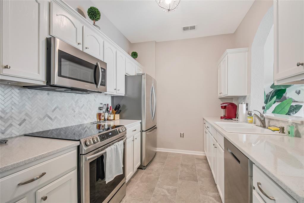 2817 Almaton Loop, Unit 301 Kissimmee, FL 34747 - Photo 9 of 51 a kitchen with a sink stove and refrigerator