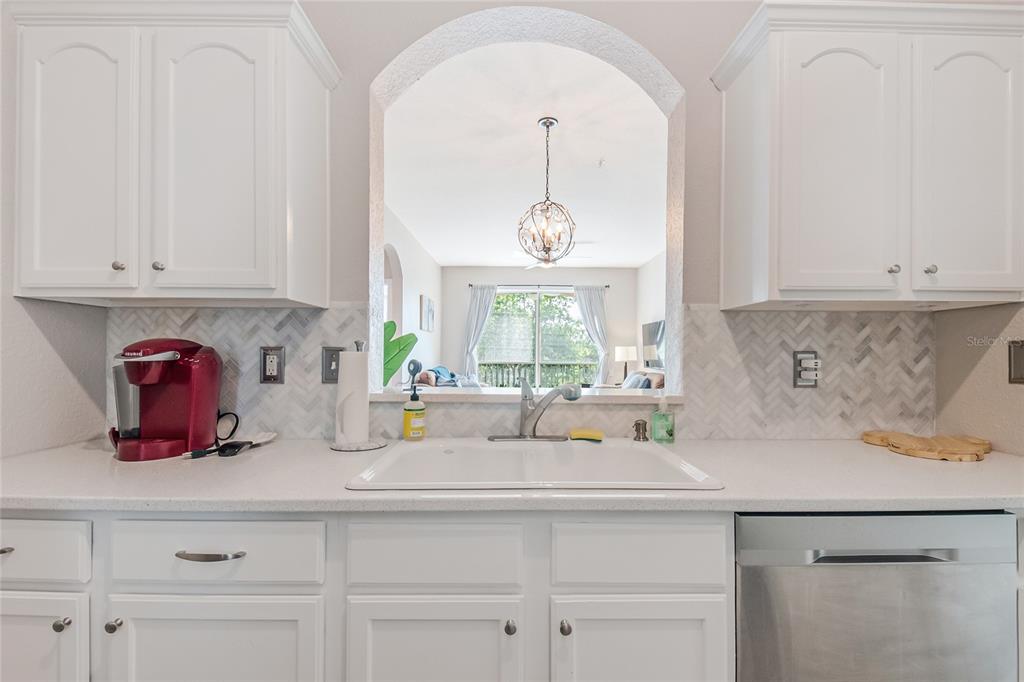 2817 Almaton Loop, Unit 301 Kissimmee, FL 34747 - Photo 10 of 51 a kitchen with white cabinets and window
