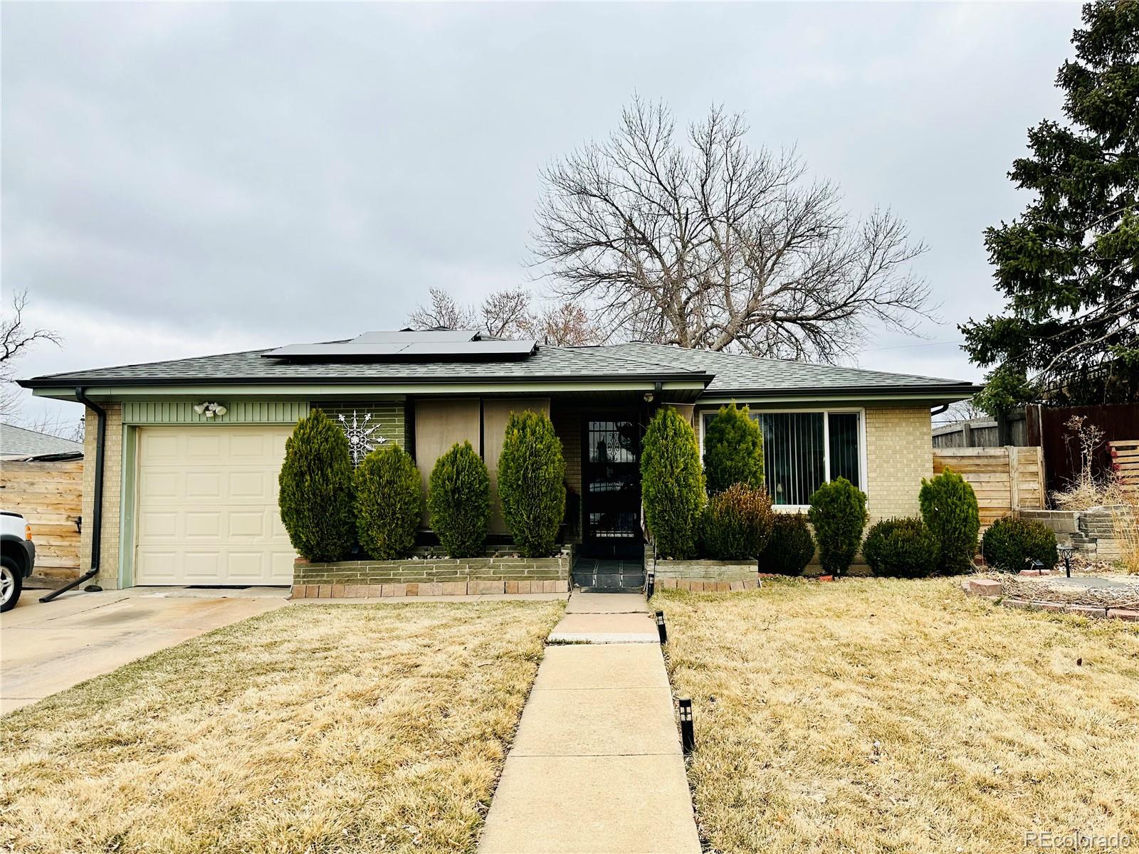 662 South Tejon Street Denver, CO 80223 - Photo 1 of 19 a front view of a house with a yard and potted plants