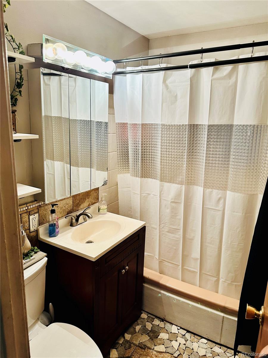 662 South Tejon Street Denver, CO 80223 - Photo 11 of 19 a bathroom with a sink vanity mirror and toilet