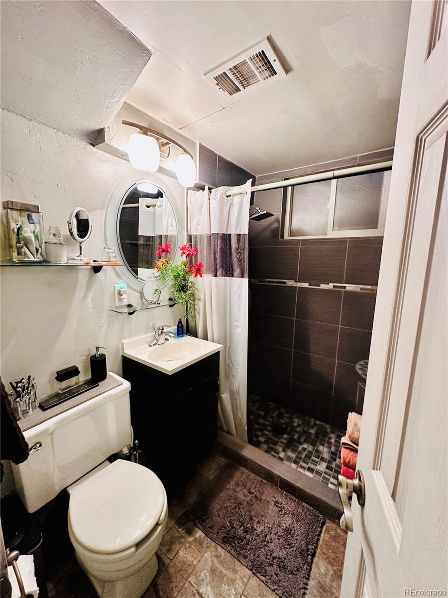 662 South Tejon Street Denver, CO 80223 - Photo 12 of 19 a bathroom with a sink toilet and shower