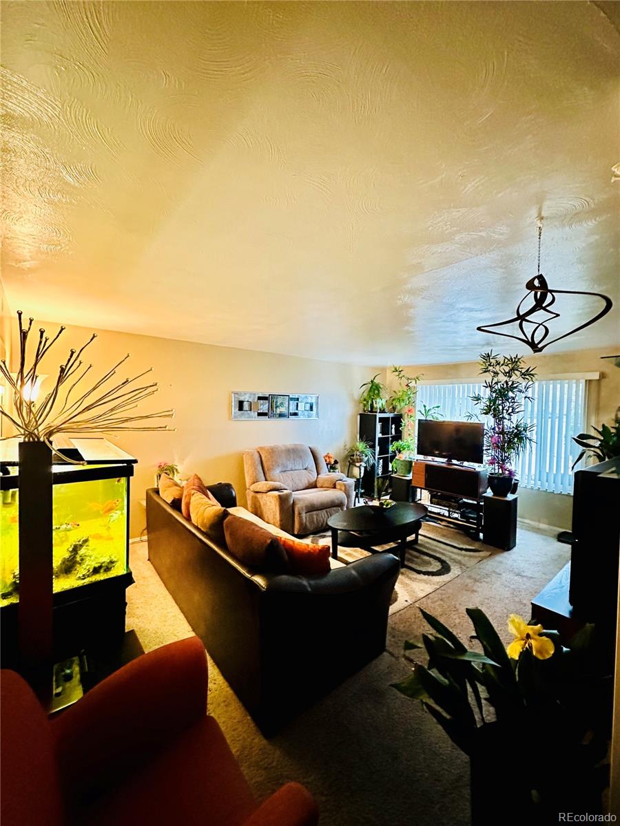 662 South Tejon Street Denver, CO 80223 - Photo 6 of 19 a living room with furniture a flat screen tv and floor to ceiling window