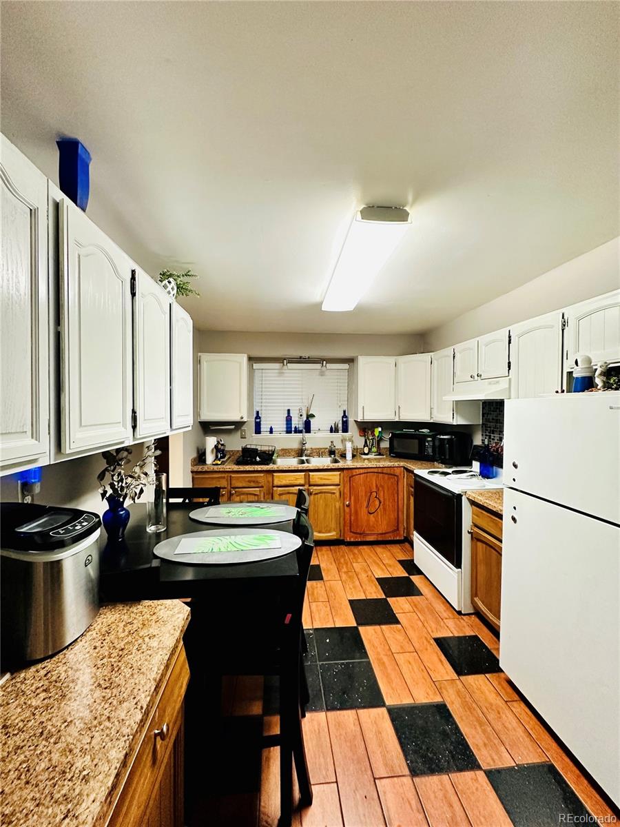 662 South Tejon Street Denver, CO 80223 - Photo 7 of 19 a kitchen with a sink stove and cabinets