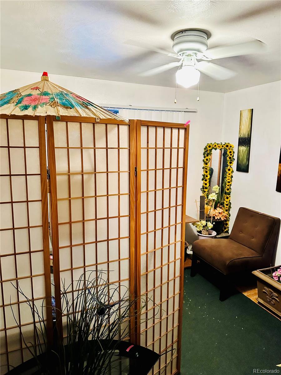662 South Tejon Street Denver, CO 80223 - Photo 10 of 19 a bedroom with furniture and a chandelier
