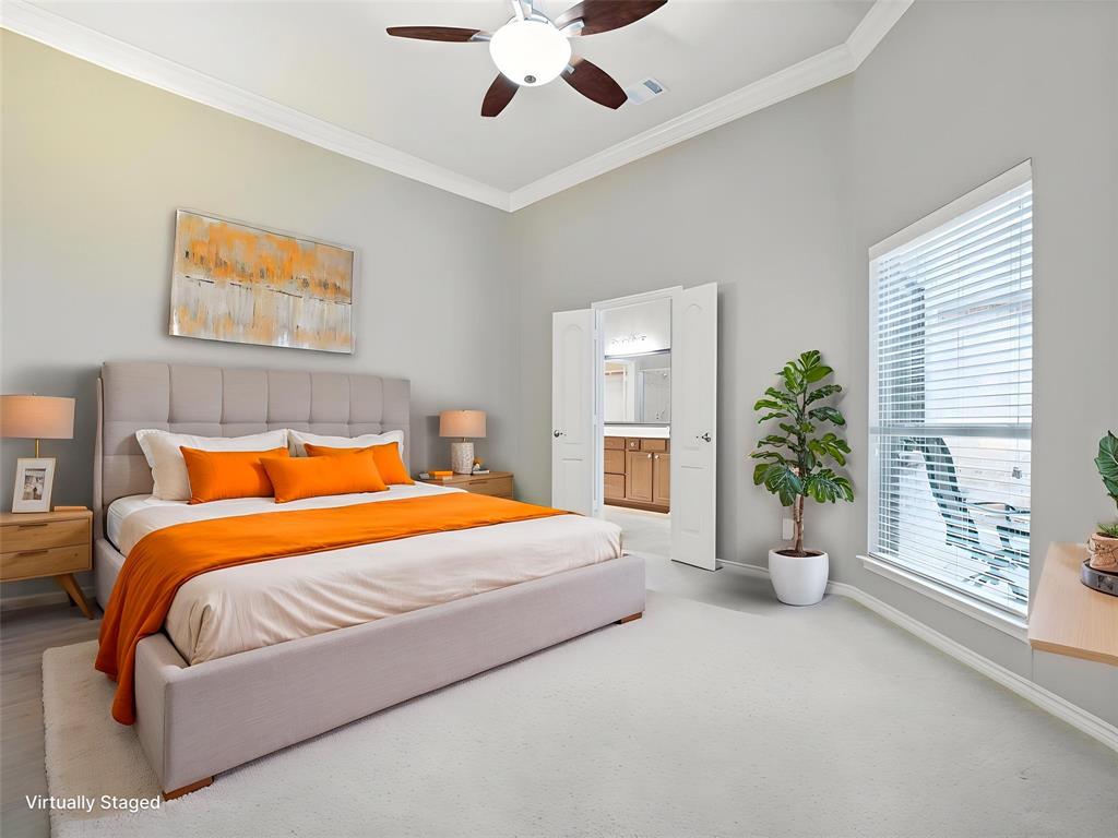 10032 Bell Rock Road Frisco, TX 75035 - Photo 18 of 23 Carpeted bedroom featuring an upholstered headboard, a ceiling fan with integrated lighting, crown molding, and large windows with blinds