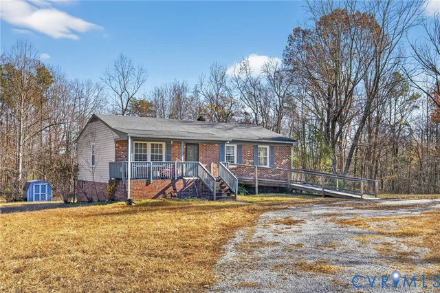 a view of a house with backyard and a tree