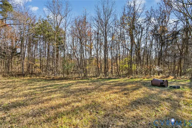 a view of outdoor space with patio and wooden fence