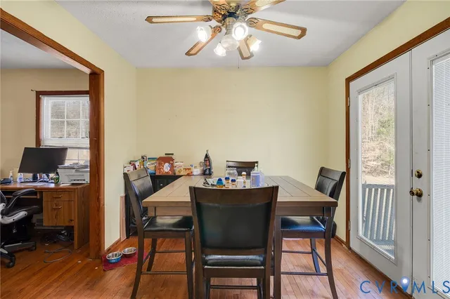 a view of a dining room with furniture and wooden floor