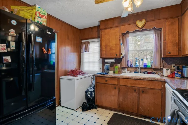 a kitchen with a sink cabinets and window