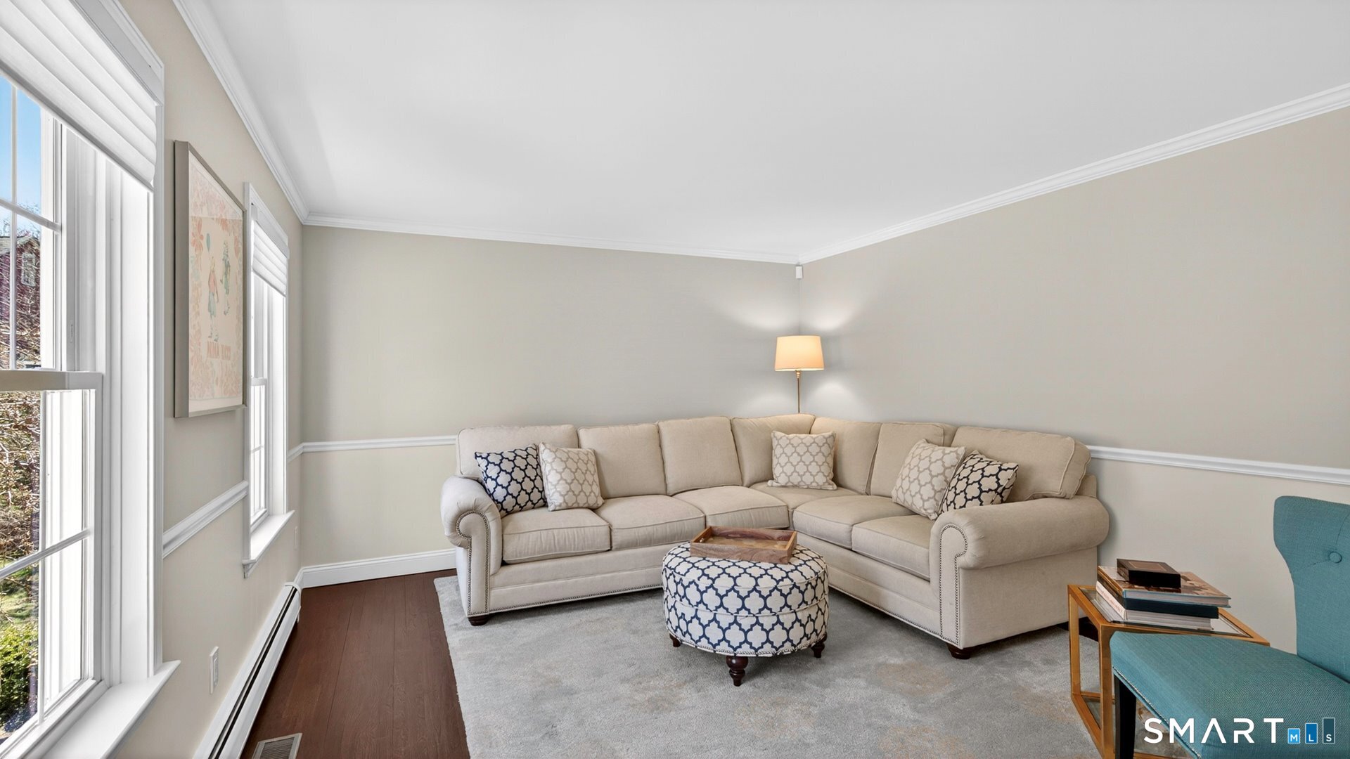 389 Huckleberry Hill Road Avon, CT 06001 - Photo 15 of 35 Bright living room with chair rail and crown molding.