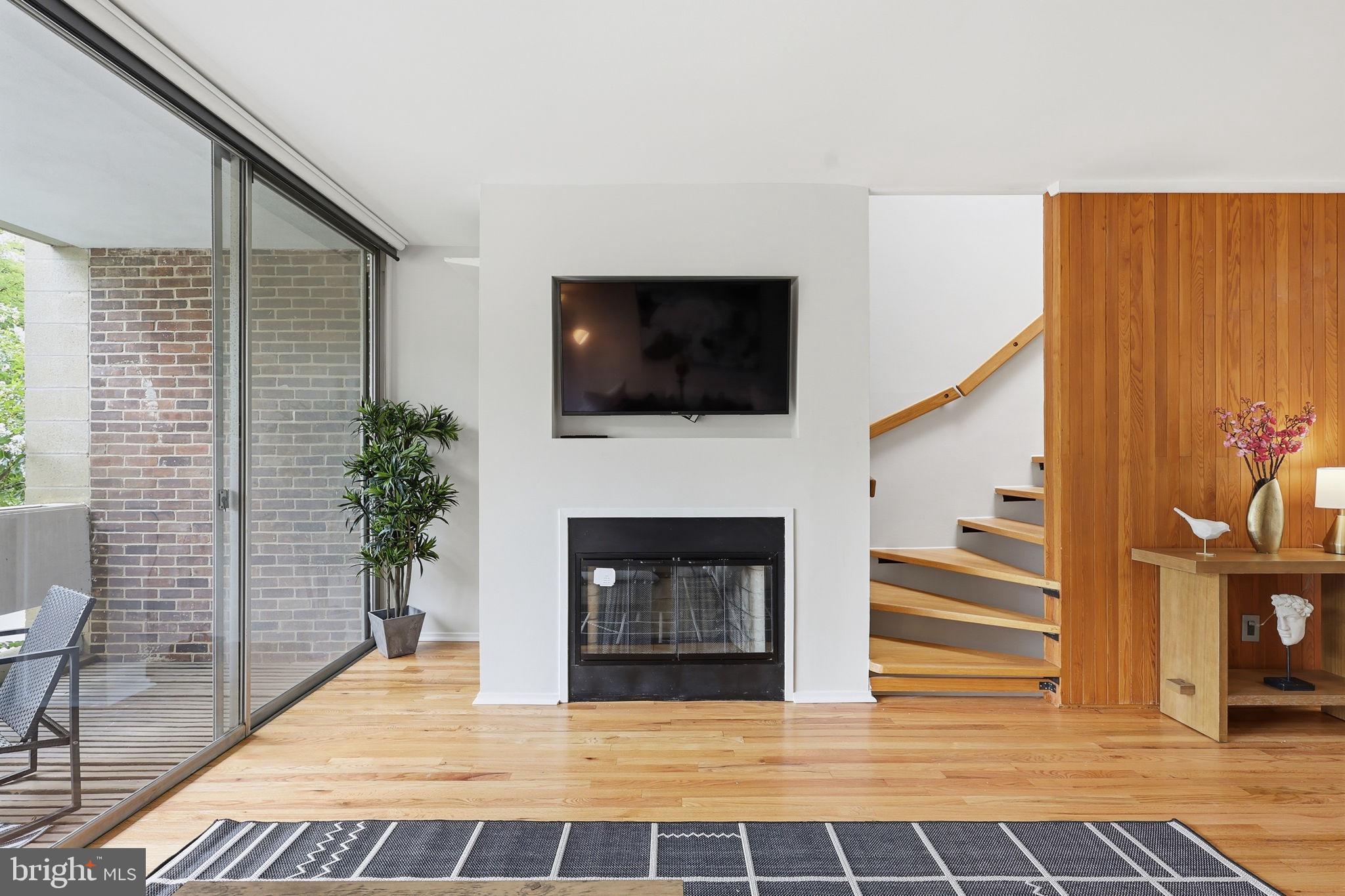 11510 Maple Ridge Road Reston, VA 20190 - Photo 12 of 43 a living room with furniture a fireplace and a flat screen tv