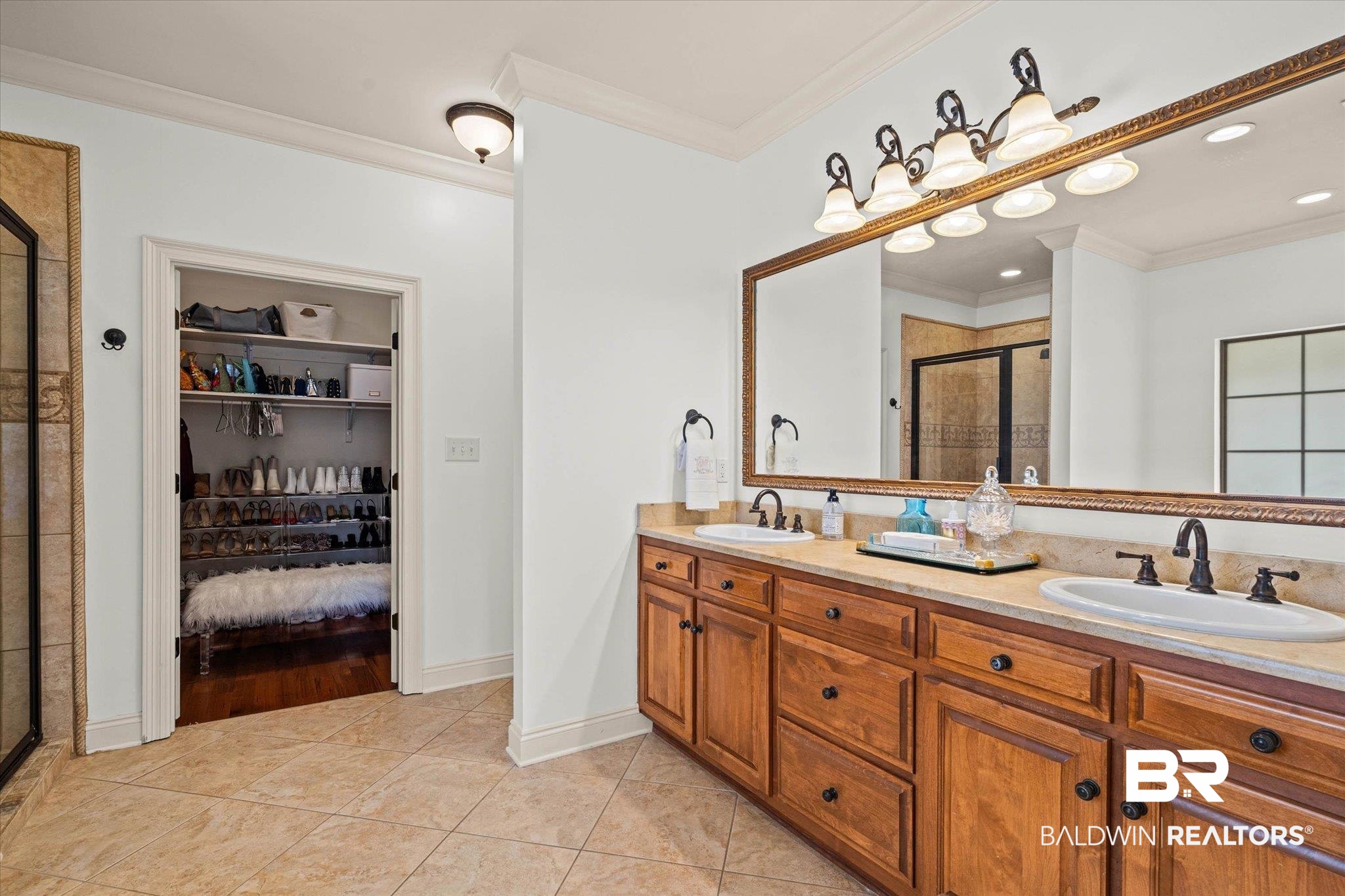 3459 Rue Royal Mobile, AL 36693 - Photo 16 of 31 Double vanity with wood cabinetry, light-toned countertop, and bronze fixtures