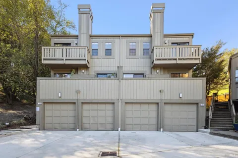 a view of a house with a wooden fence
