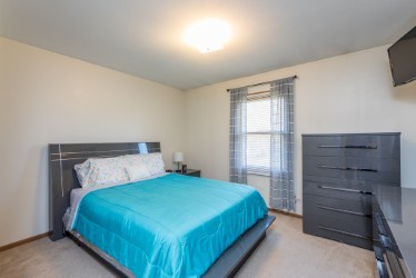 724 Roberts Road Winthrop Harbor, IL 60096 - Photo 14 of 31 a bedroom with a bed and a window