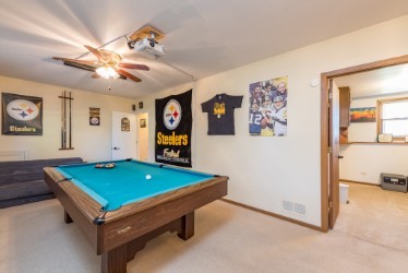 724 Roberts Road Winthrop Harbor, IL 60096 - Photo 17 of 31 a room with pool table and paintings on the wall