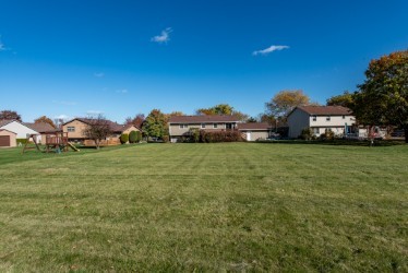 724 Roberts Road Winthrop Harbor, IL 60096 - Photo 29 of 31 a view of yard with house and car parked