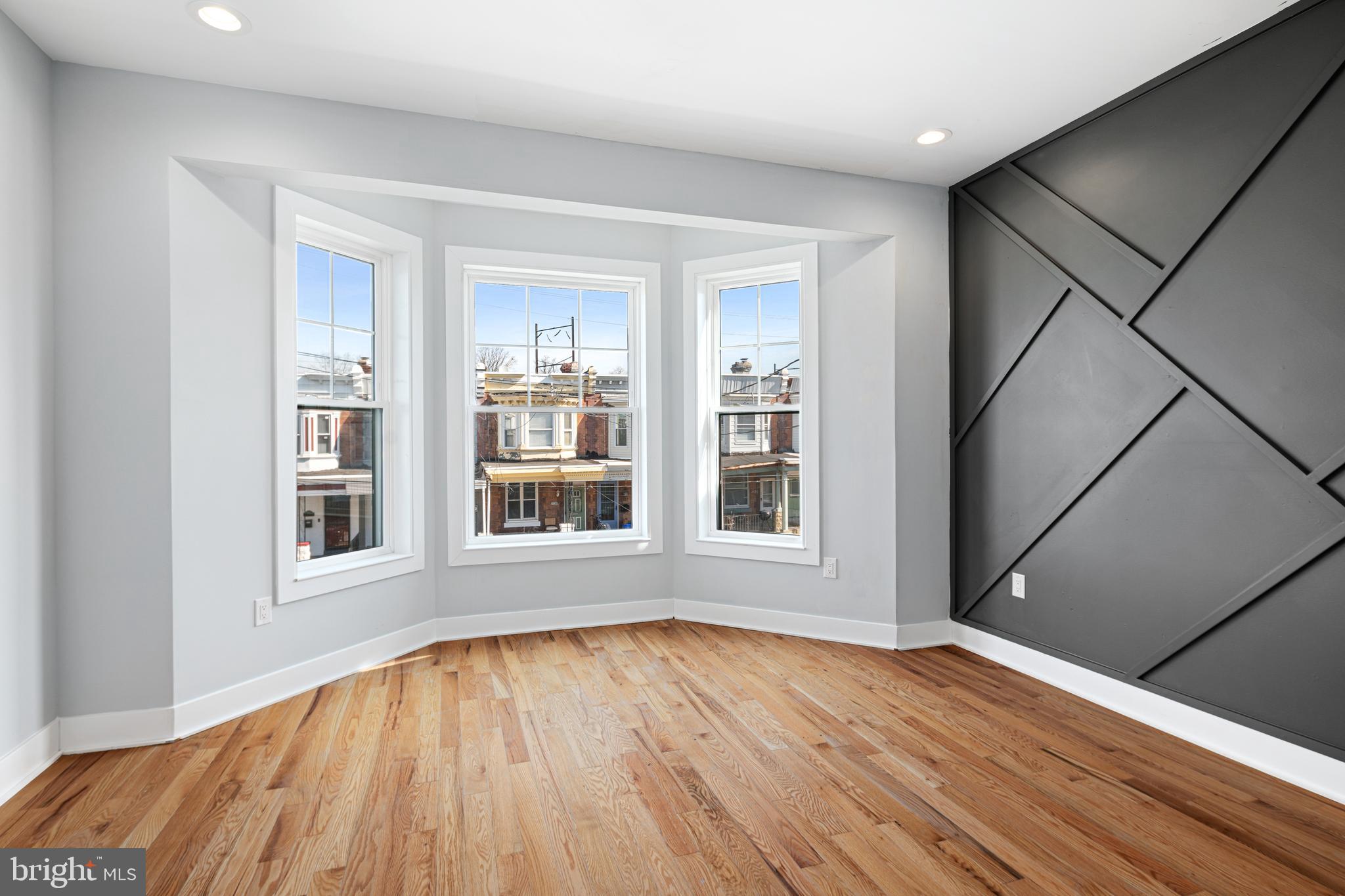 1124 Divinity Street Philadelphia, PA 19143 - Photo 14 of 37 a view of an empty room with wooden floor and a window