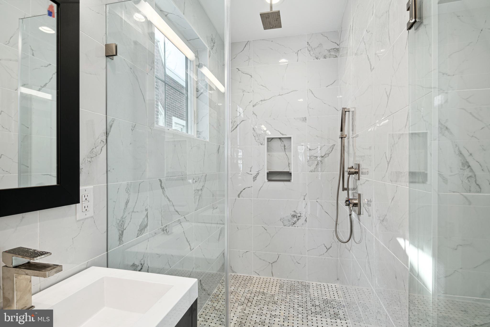 1124 Divinity Street Philadelphia, PA 19143 - Photo 19 of 37 a bathroom with a sink shower and a mirror