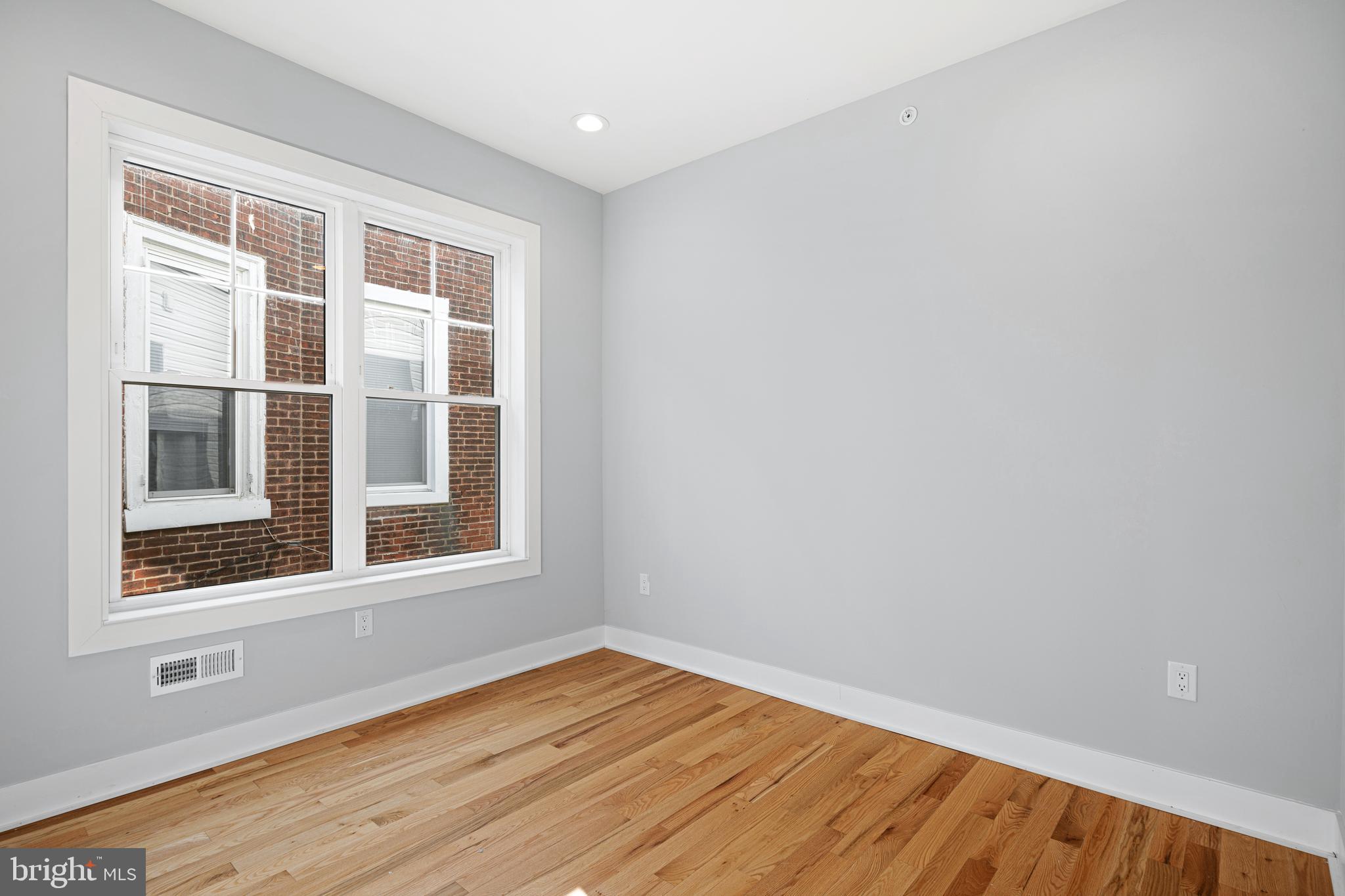 1124 Divinity Street Philadelphia, PA 19143 - Photo 22 of 37 a view of empty room with wooden floor and fan