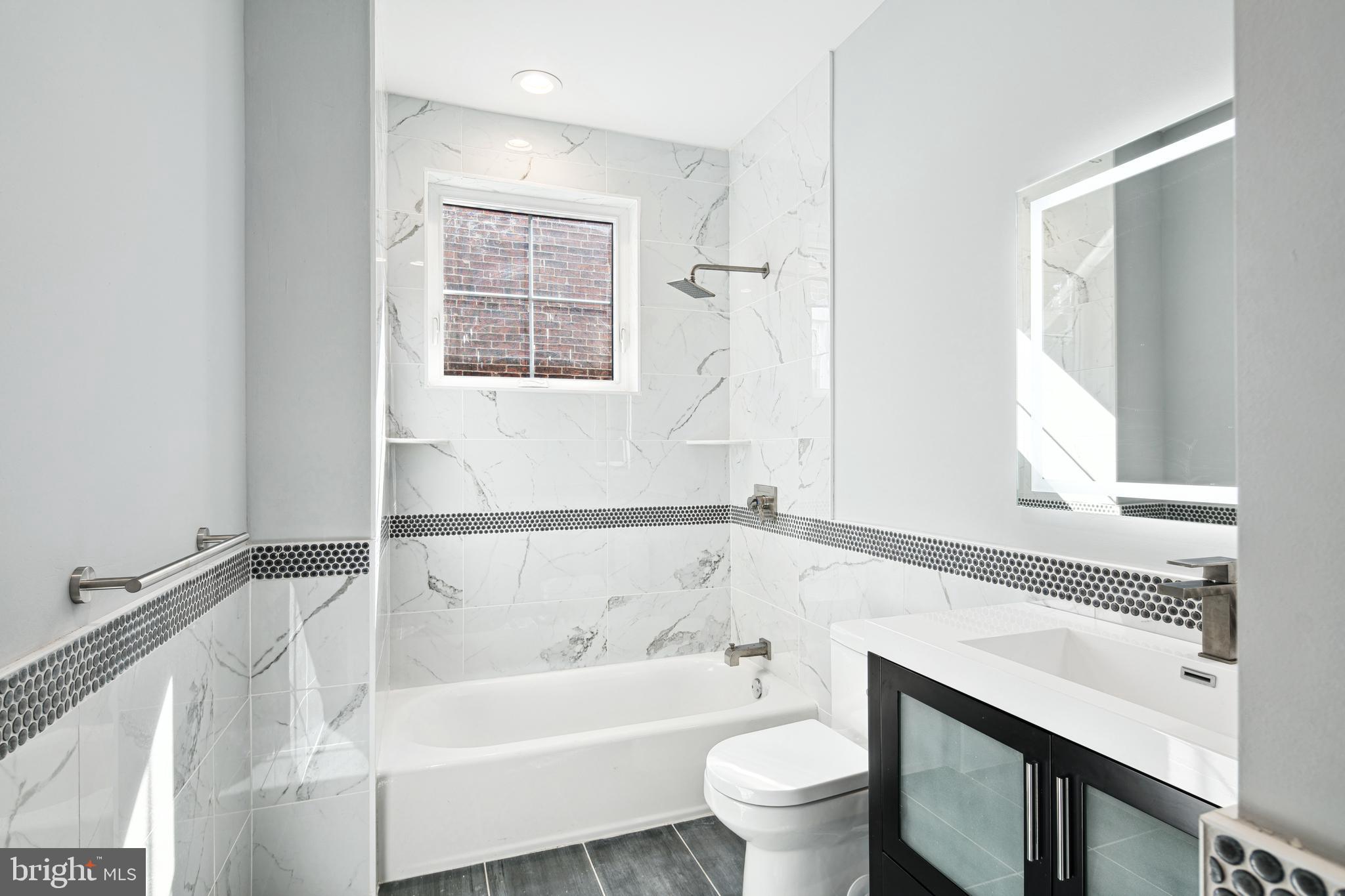 1124 Divinity Street Philadelphia, PA 19143 - Photo 23 of 37 a bathroom with a bathtub sink and toilet
