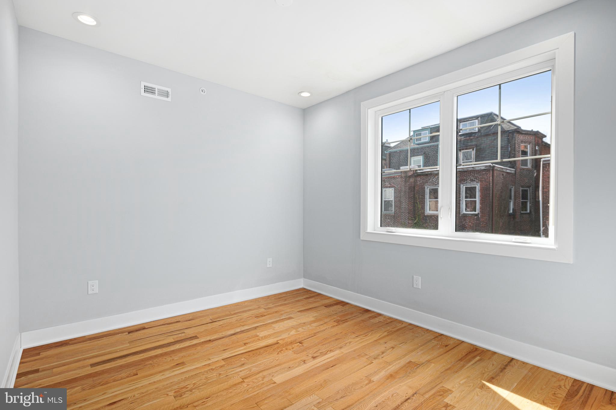 1124 Divinity Street Philadelphia, PA 19143 - Photo 25 of 37 a view of empty room with wooden floor and fan