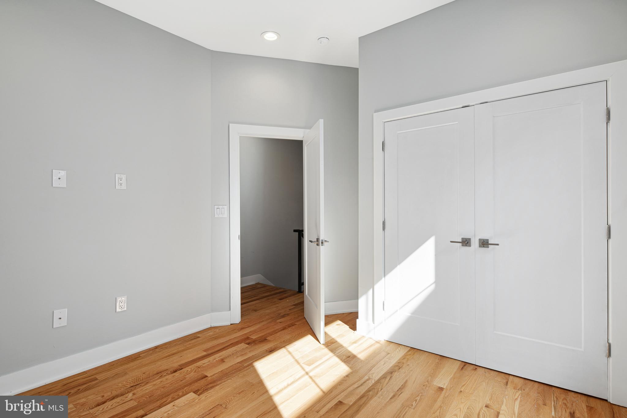 1124 Divinity Street Philadelphia, PA 19143 - Photo 26 of 37 an empty room with wooden floor and entrance