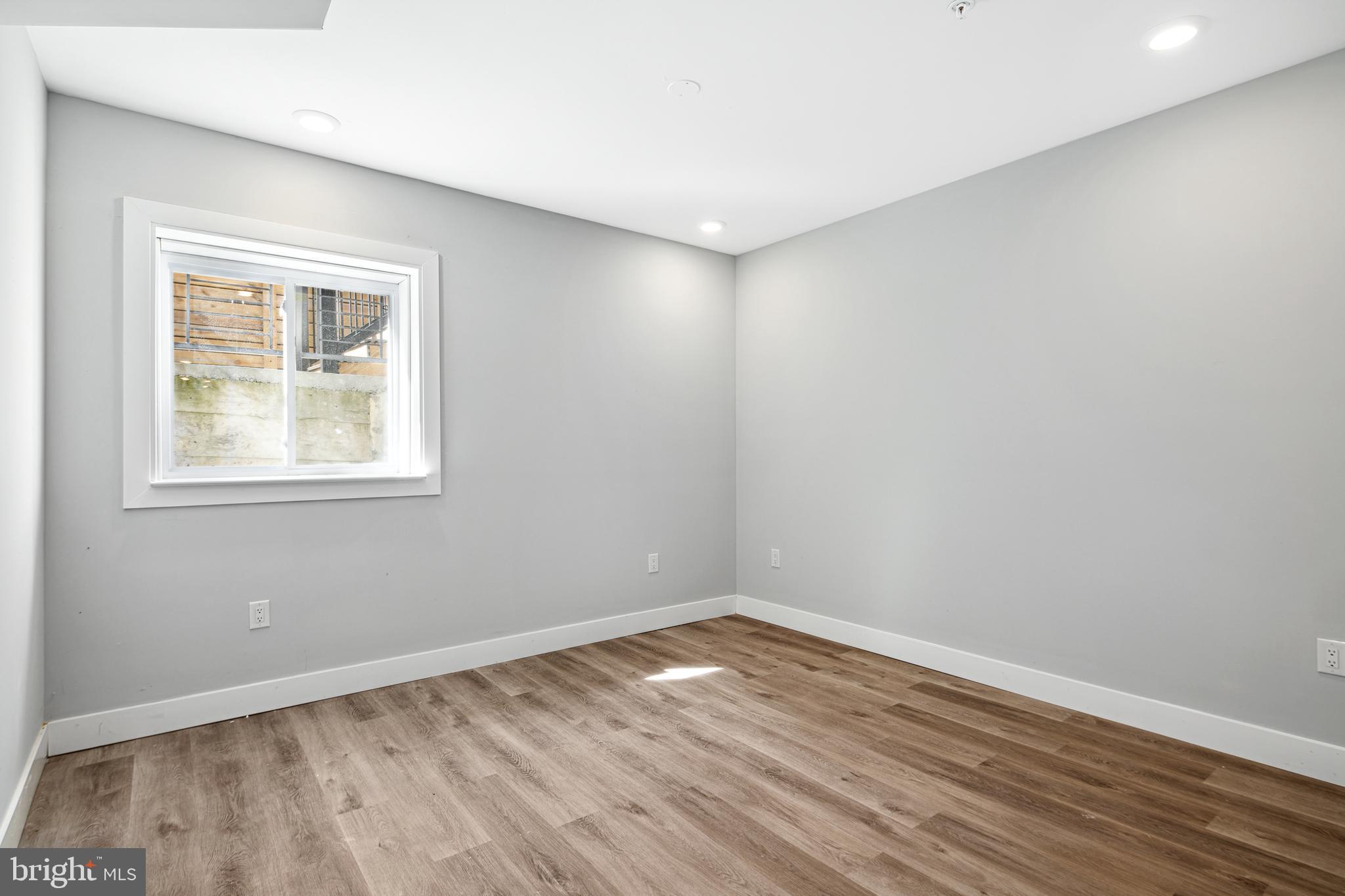 1124 Divinity Street Philadelphia, PA 19143 - Photo 32 of 37 a view of empty room with wooden floor and fan
