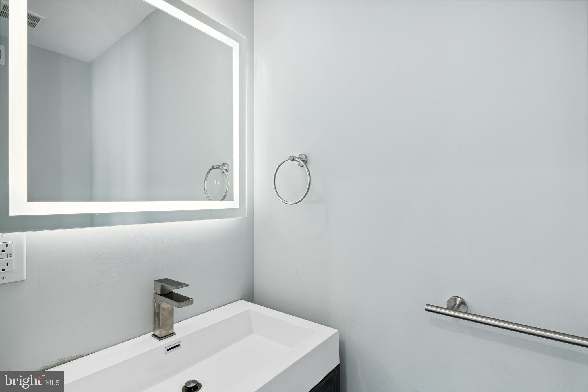 1124 Divinity Street Philadelphia, PA 19143 - Photo 34 of 37 a bathroom with a sink and mirror