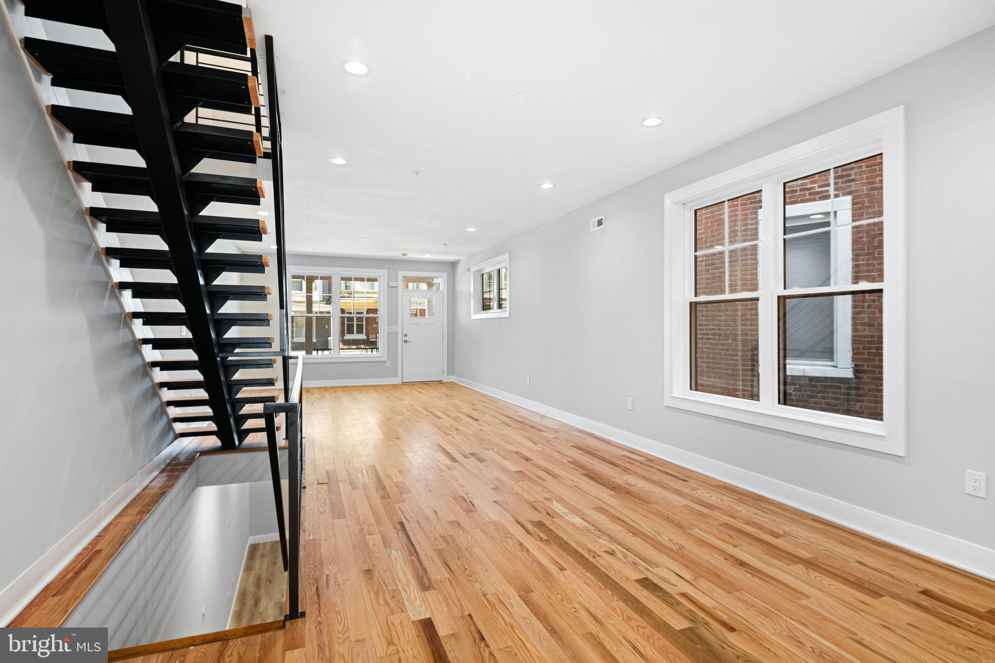 1124 Divinity Street Philadelphia, PA 19143 - Photo 5 of 37 wooden floor in an empty room with a window