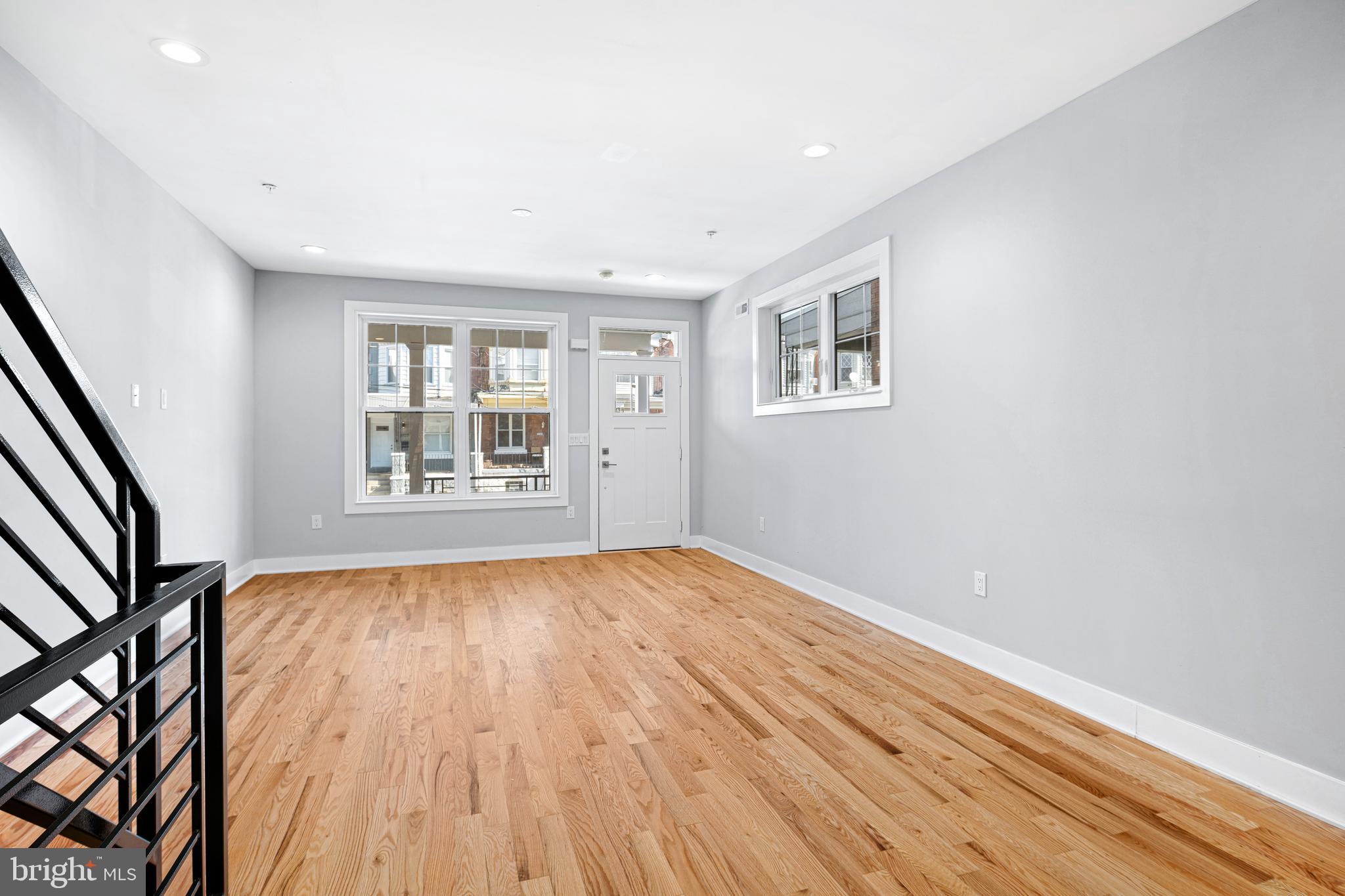 1124 Divinity Street Philadelphia, PA 19143 - Photo 6 of 37 wooden floor in an empty room with a window