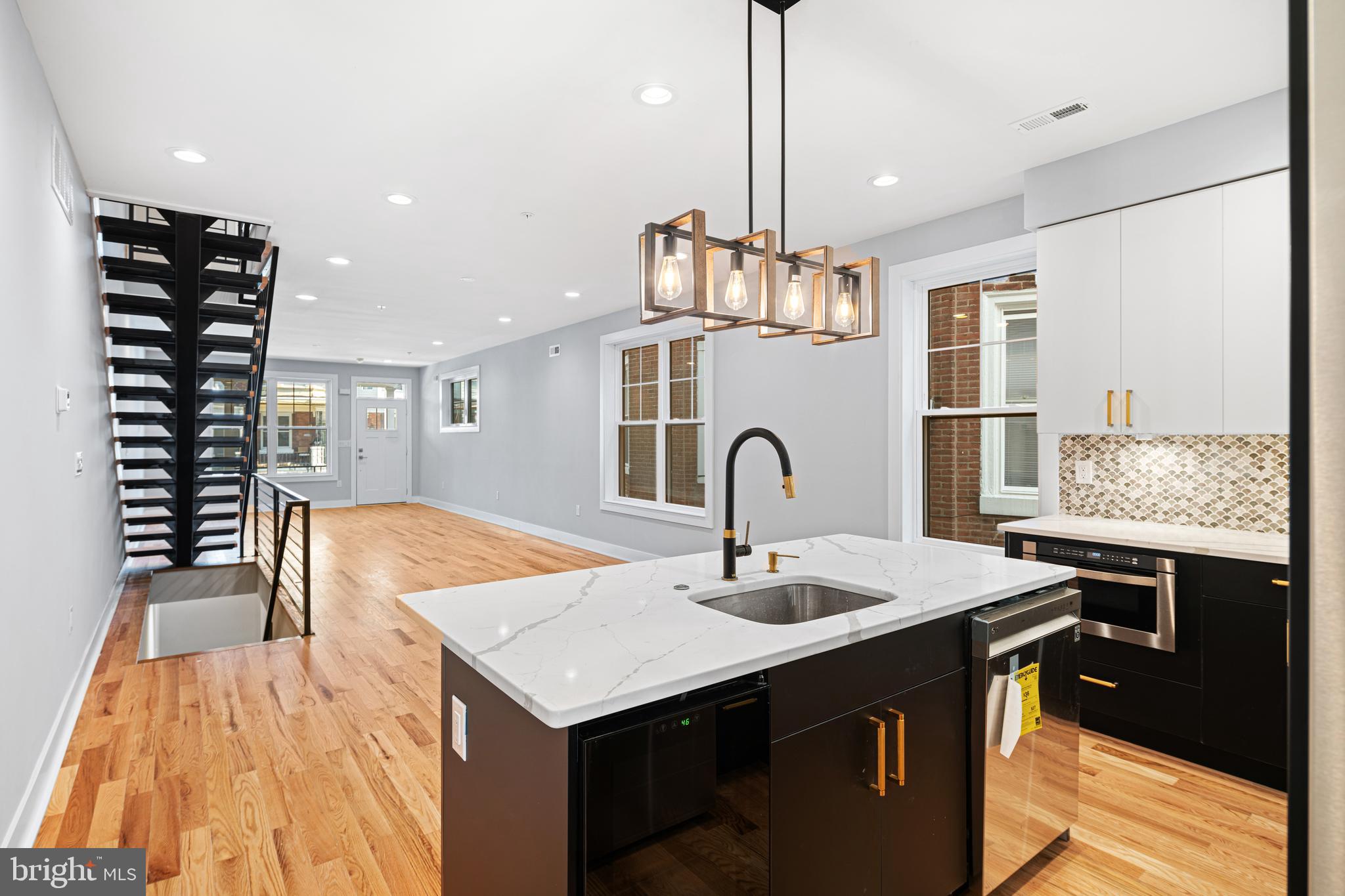 1124 Divinity Street Philadelphia, PA 19143 - Photo 9 of 37 a kitchen with a sink cabinets and wooden floor