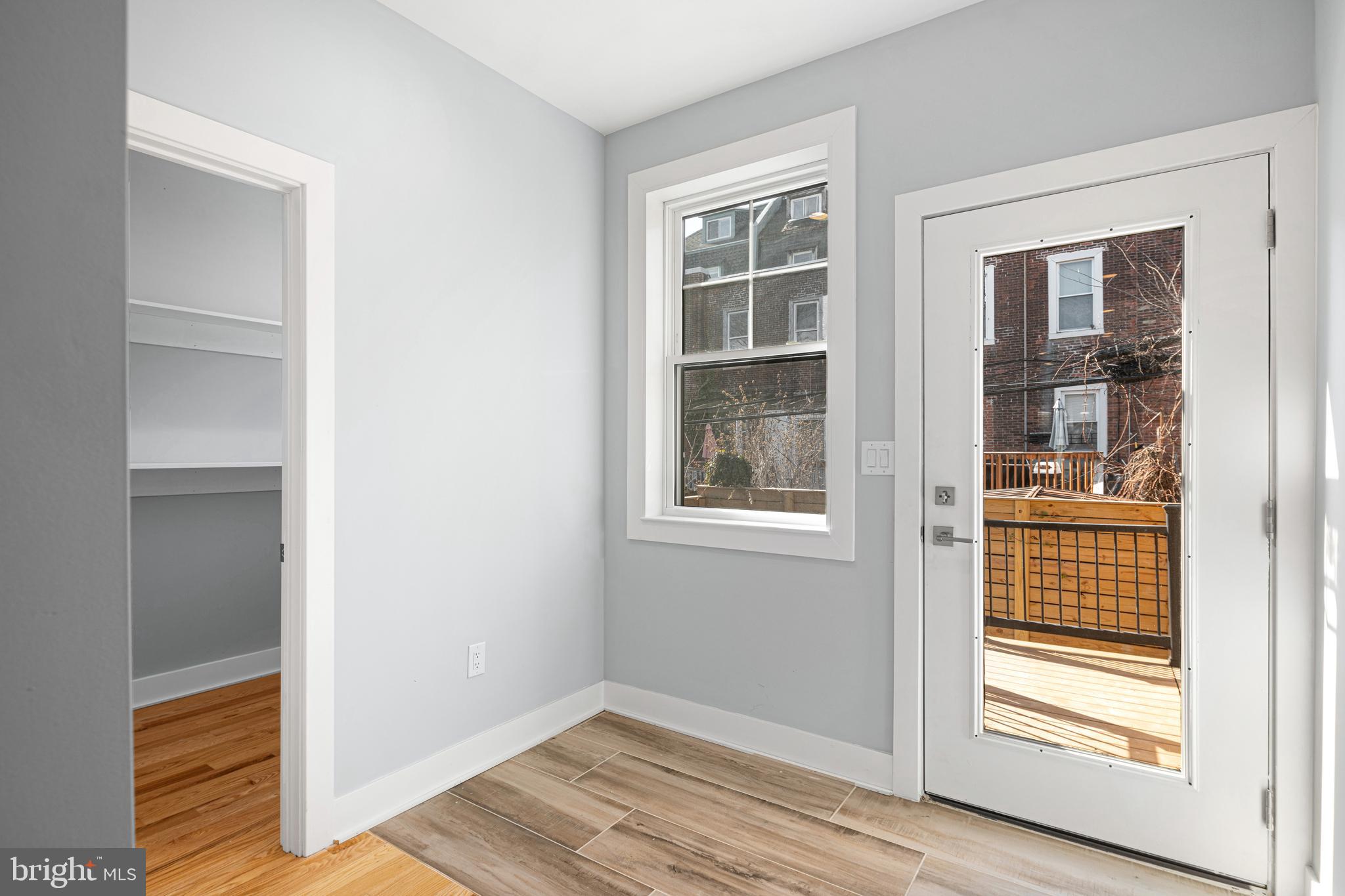 1124 Divinity Street Philadelphia, PA 19143 - Photo 10 of 37 a view of an empty room with wooden floor and a window