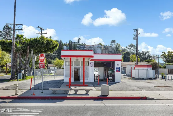 a view of a rooftop with tables and chairs