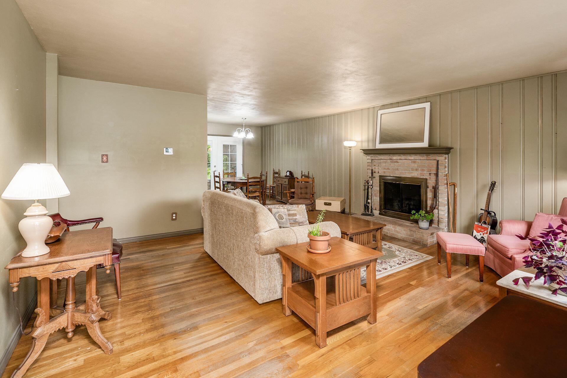 350 Jefferson Road Newark, OH 43055 - Photo 6 of 38 Large great room with fireplace and hardwood flooring is open to dining area.
