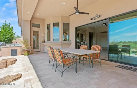 a view of a patio with a dining table and chairs with wooden floor