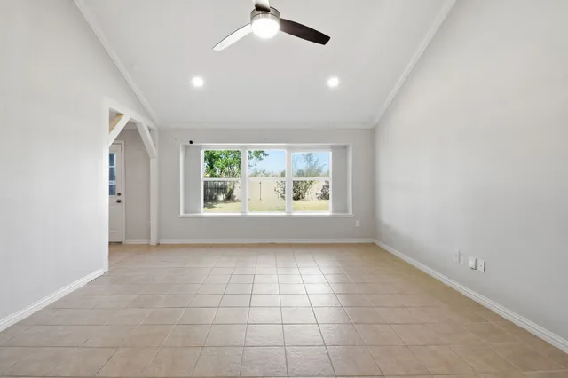 an empty room with windows and entrance