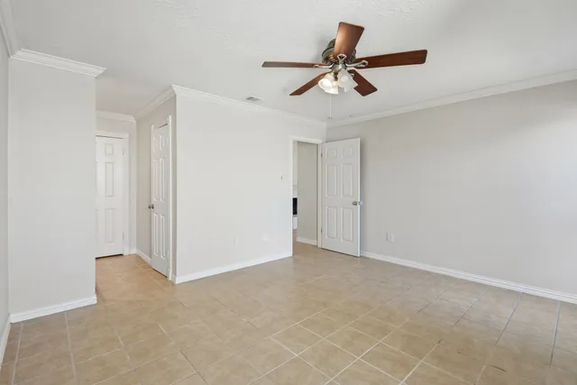 an empty room with closet and windows