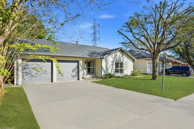 a view of a house with a yard and pathway