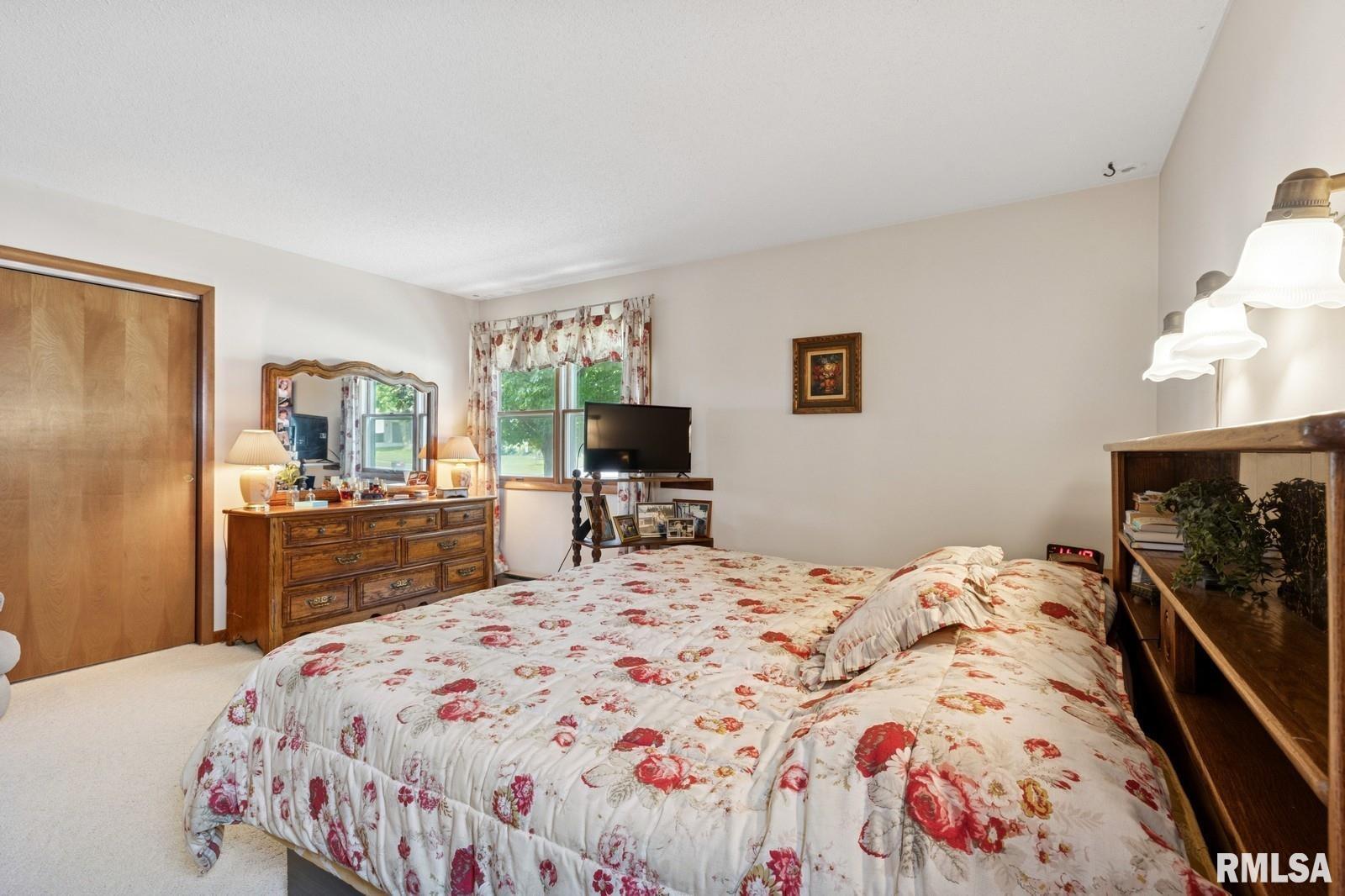 1825 5th Avenue South Clinton, IA 52732 - Photo 13 of 34 a bedroom with a bed and a flat screen tv