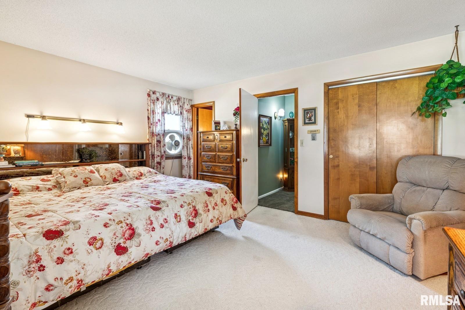 1825 5th Avenue South Clinton, IA 52732 - Photo 14 of 34 a bedroom with a large bed and a couch