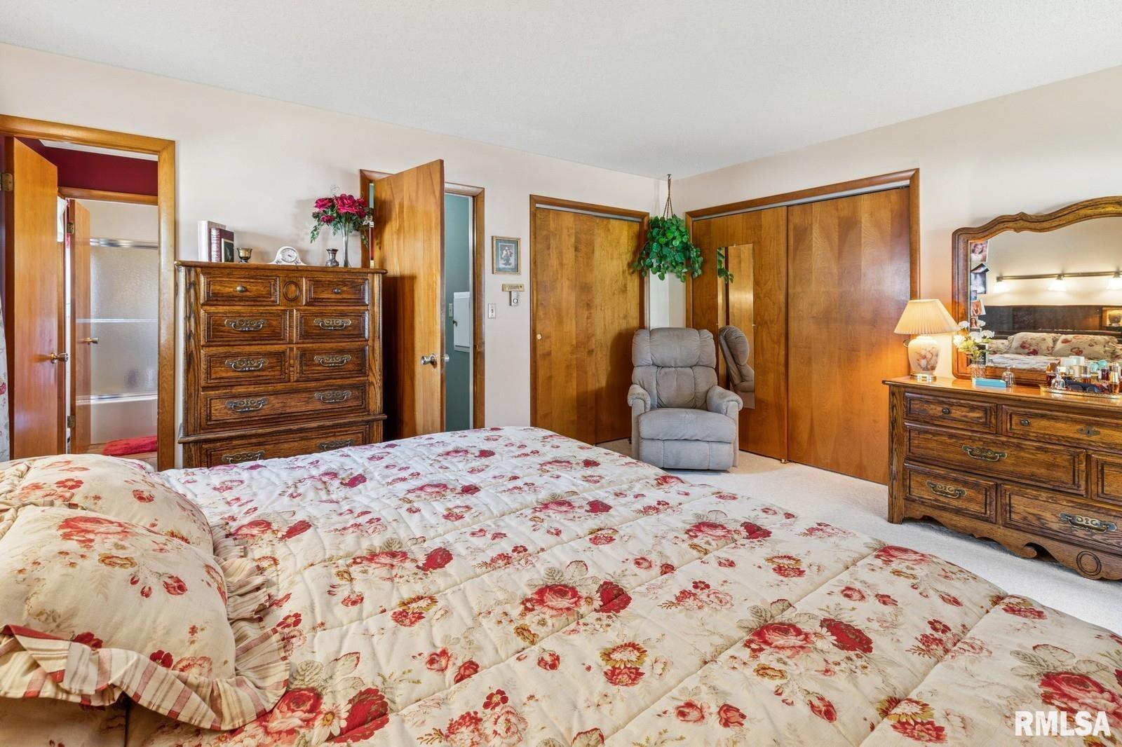 1825 5th Avenue South Clinton, IA 52732 - Photo 15 of 34 a bedroom with a bed and wooden floor
