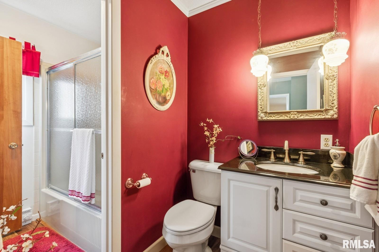 1825 5th Avenue South Clinton, IA 52732 - Photo 18 of 34 a bathroom with a toilet sink vanity and mirror