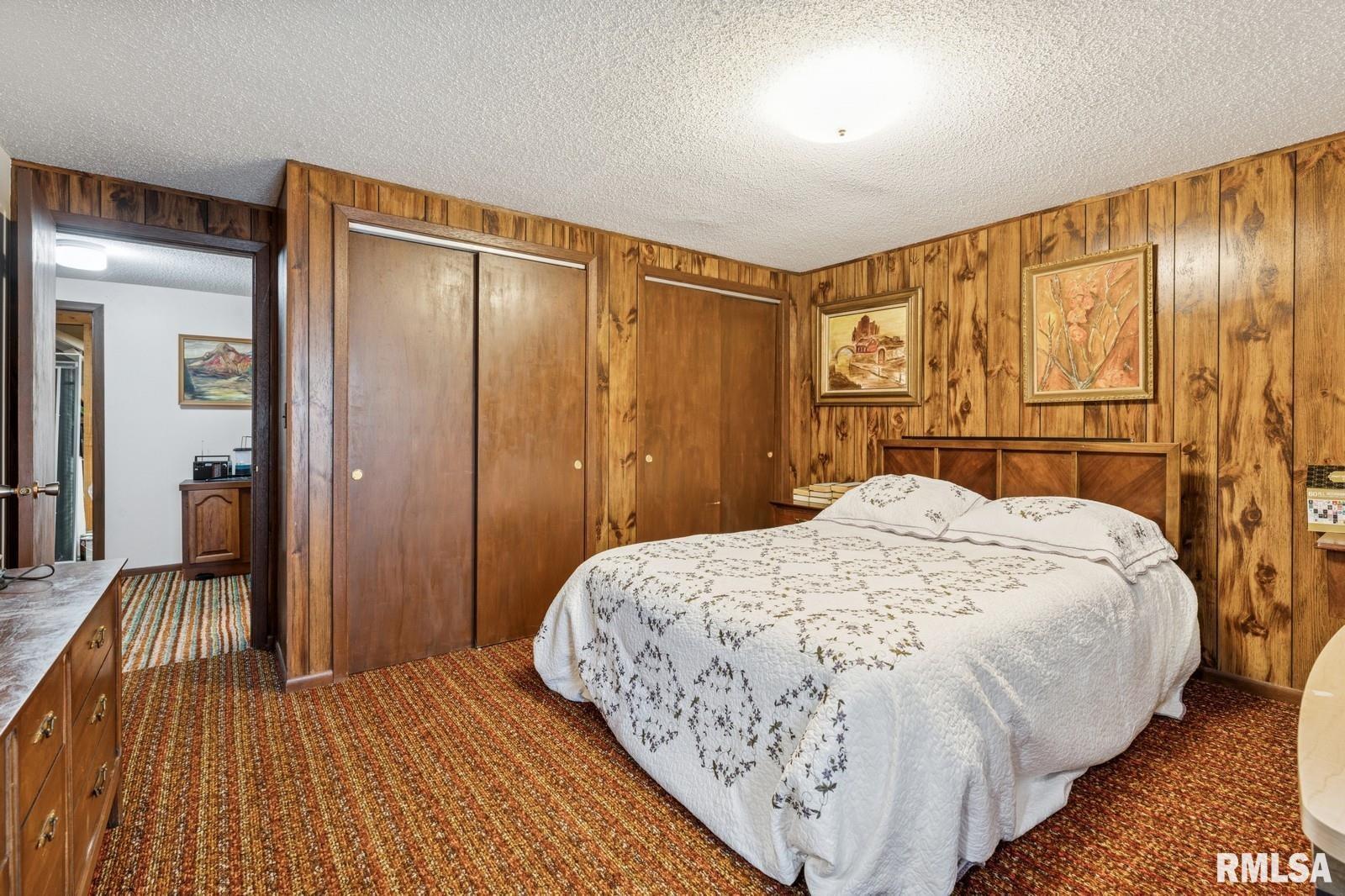 1825 5th Avenue South Clinton, IA 52732 - Photo 20 of 34 a bedroom with a large bed and a chandelier