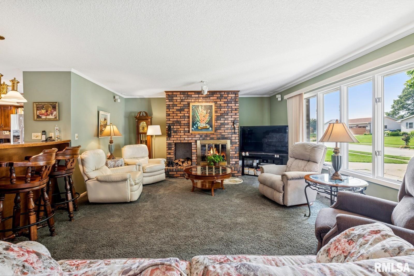 1825 5th Avenue South Clinton, IA 52732 - Photo 4 of 34 a living room with furniture and a fireplace
